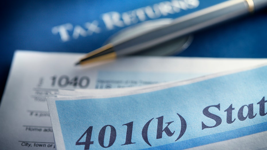 401k and tax return papers with a pen